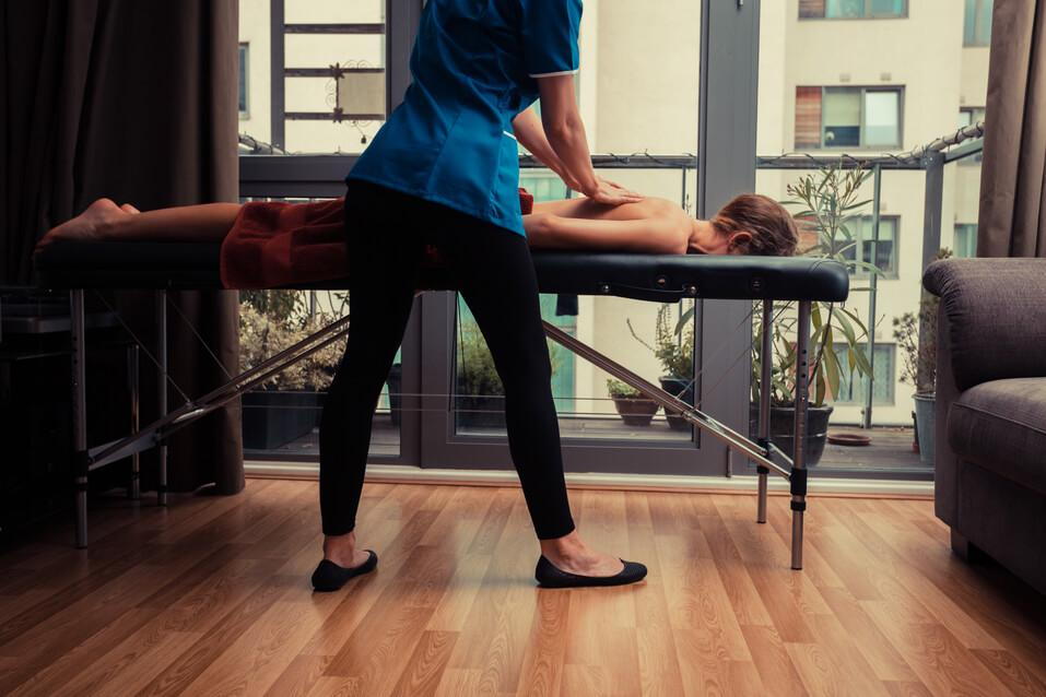 woman getting a massage first and chiropractic after