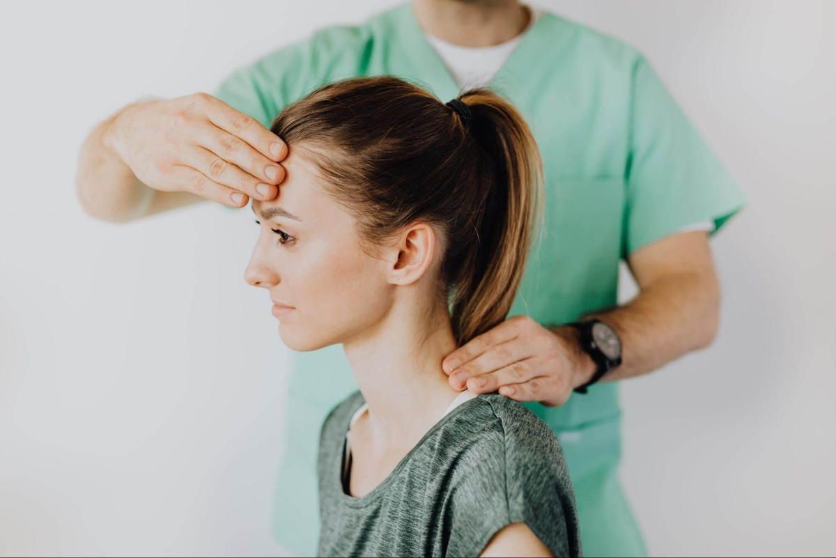chiropractor helping the patient get rid of a crick in her neck