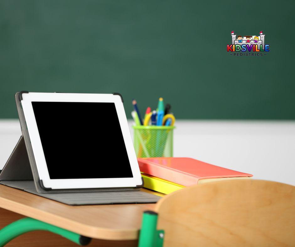 alt=A tablet placed on a classroom desk, ready for use by students.