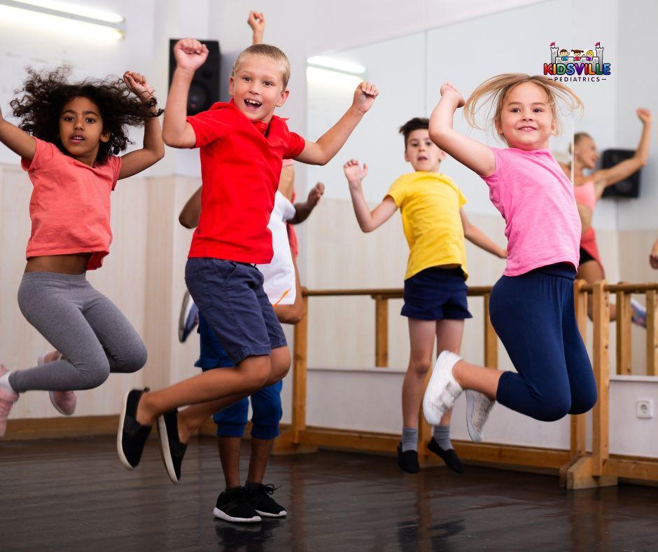 Children happily jumping and dancing in a lively dance class.