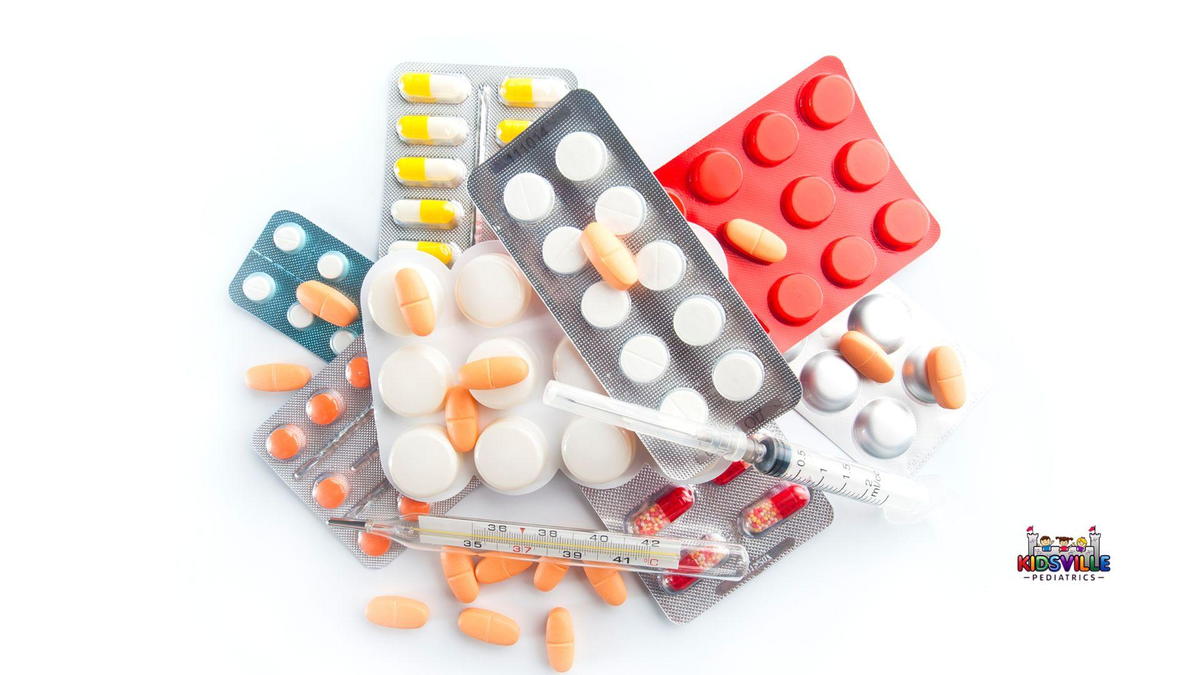 A stack of pills and tablets arranged on a white surface.