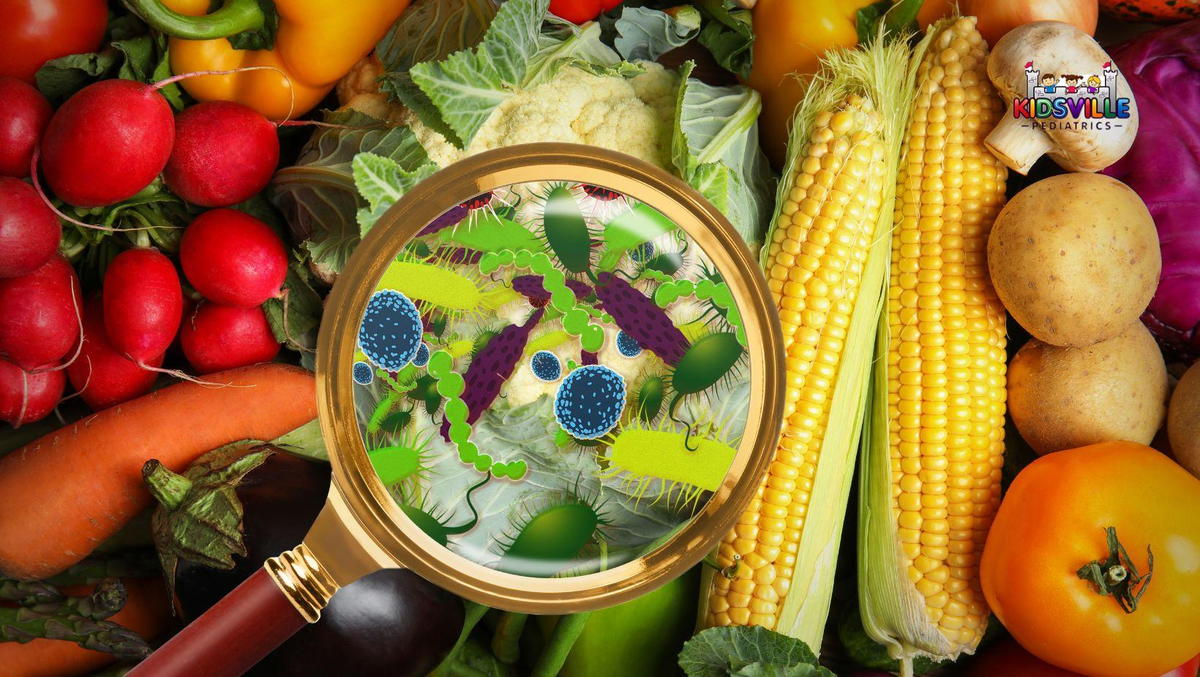 A magnifying glass on a mix of vegetables, showing germs.