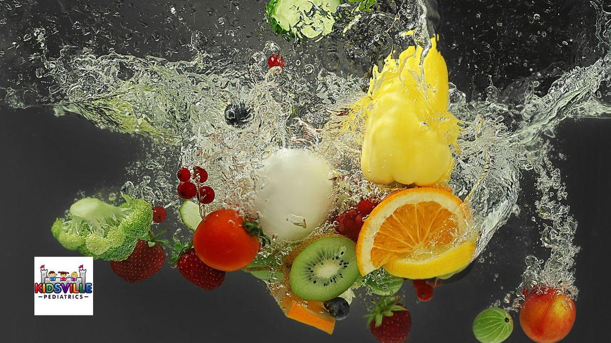 A vibrant splash of assorted fruits, including oranges, strawberries, and kiwis, creating a colorful and refreshing scene.