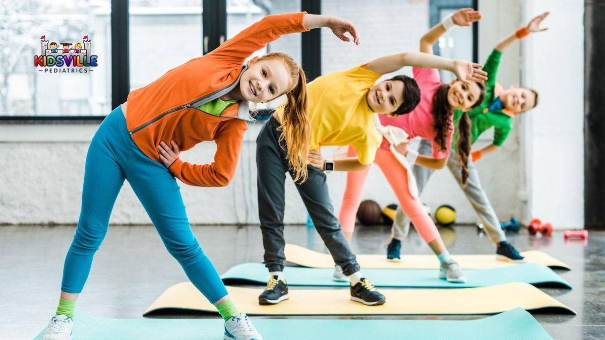 Children practicing yoga poses in a gym, focusing on balance and flexibility.