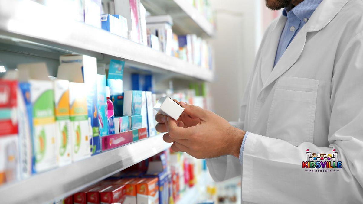A pharmacist in a pharmacy holds a box of medicine, ready to assist customers with their health needs.