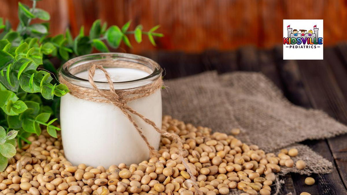 A refreshing glass of soy milk surrounded with soy beans.