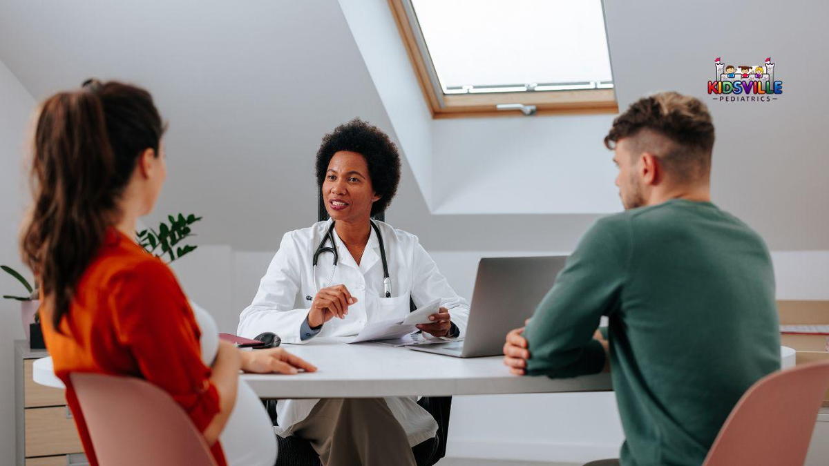 A doctor engages in conversation with a pregnant woman and her partner, seated at a table.