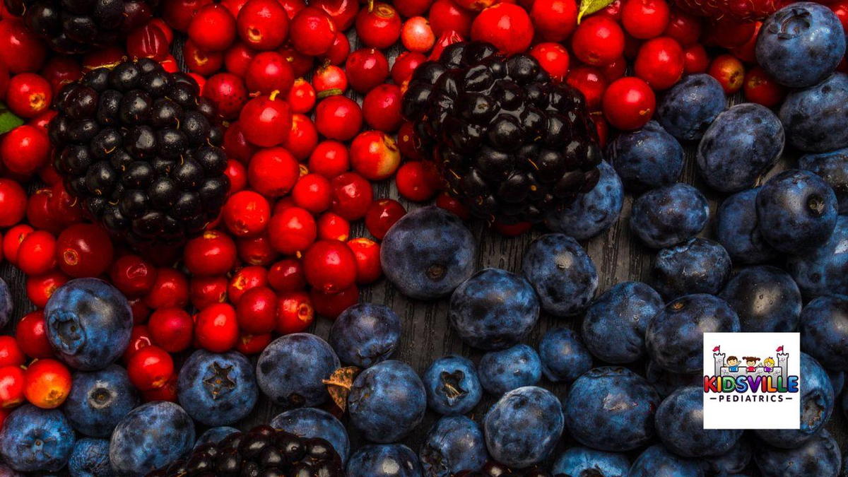 A close-up view of fresh berries, showcasing vibrant blueberries among a variety of berries.