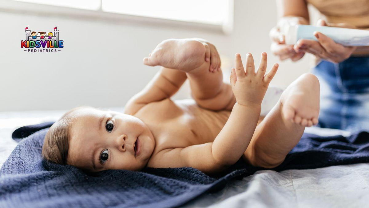 A woman with a tube of cream, getting ready to apply some on a baby's diaper rash.