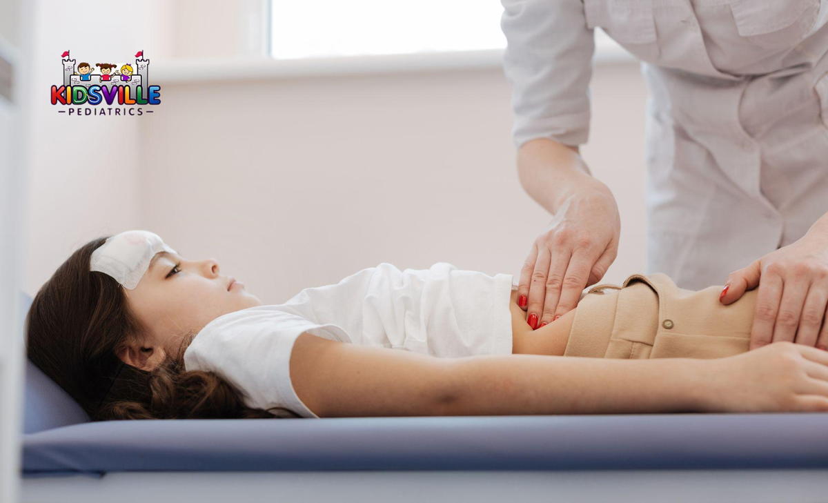 A young girl is undergoing an abdominal check-up in a clinical setting.