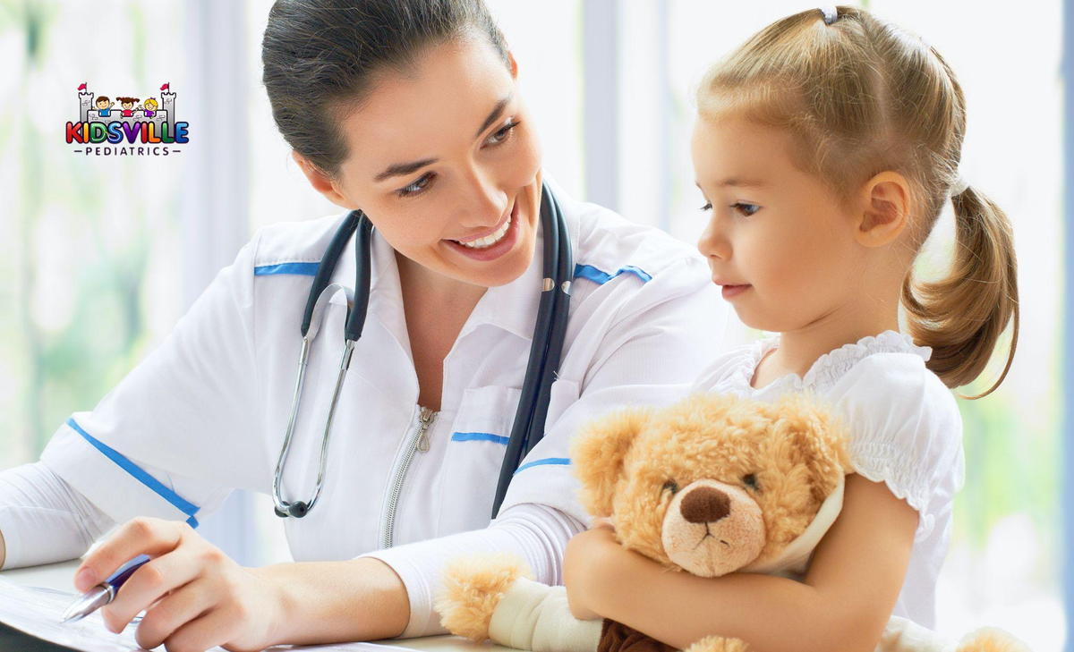 A woman wearing a stethoscope and a child are seated at a desk, sharing a moment of learning and support.