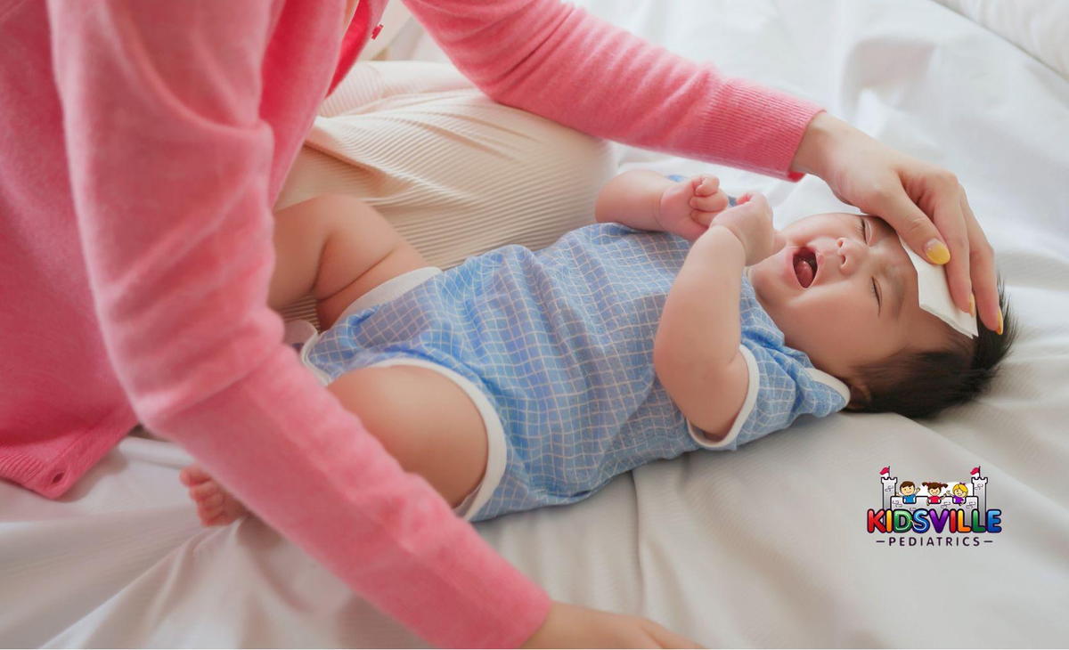 A woman caring for a baby with fever.