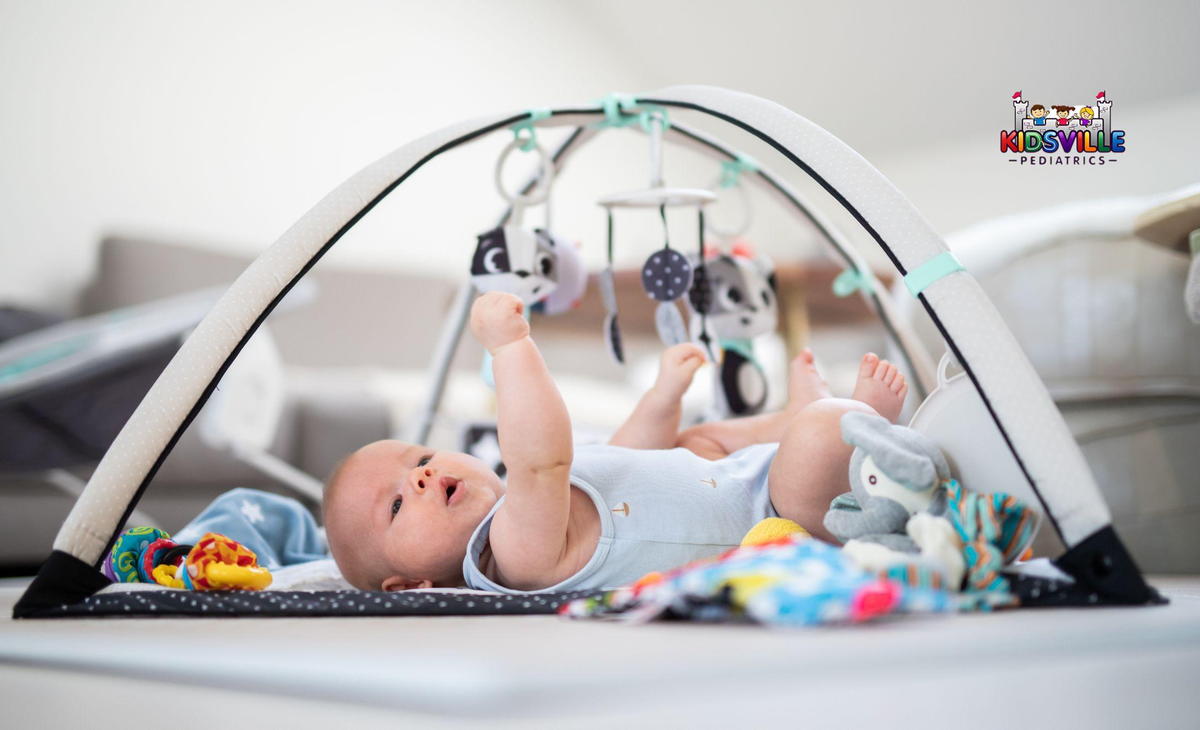 A baby joyfully plays with colorful toys inside a cozy play tent, surrounded by a cheerful atmosphere.