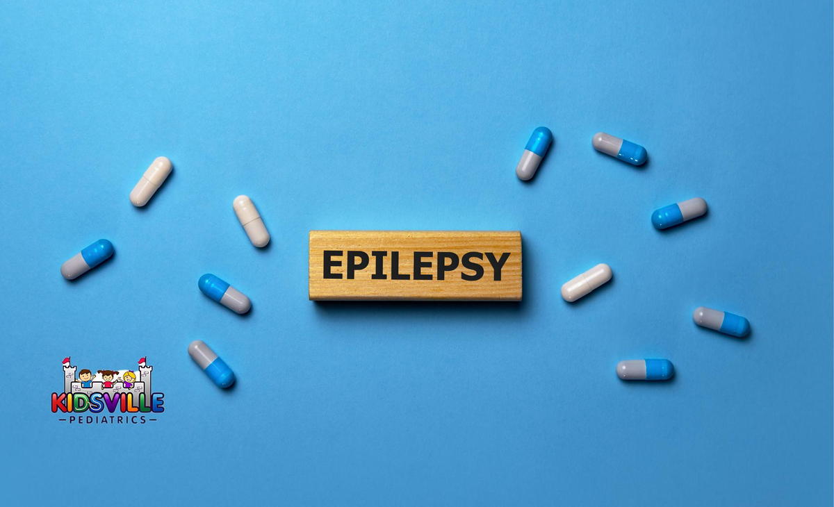 Capsules surrounding the word - EPILEPSY - written on a wooden block, indicating antiepileptic drugs.