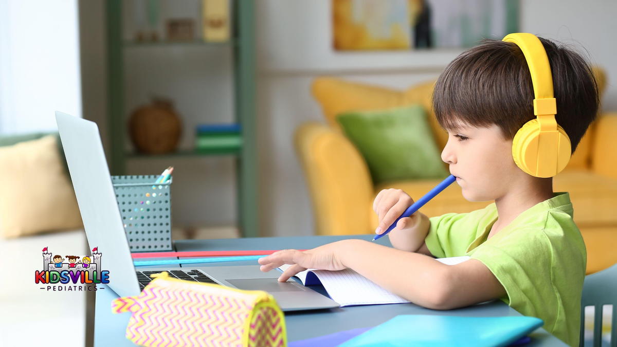 A boy in front of his study laptop, deep in thought.