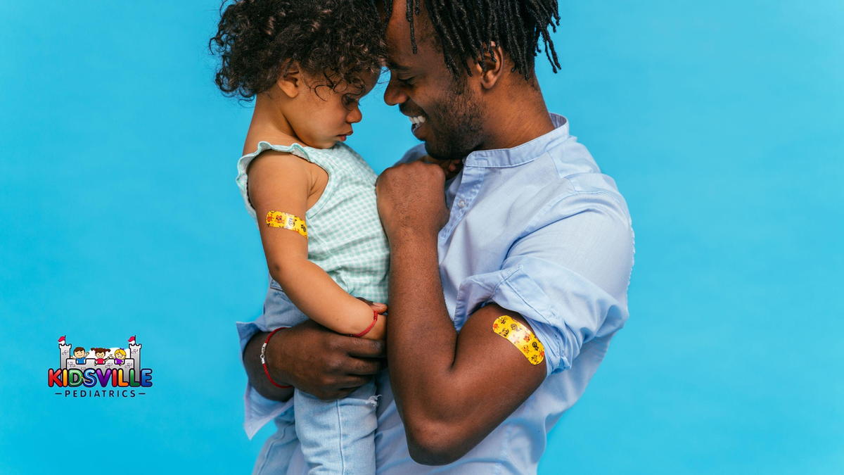 A man and his child showing their vaccinated arms.