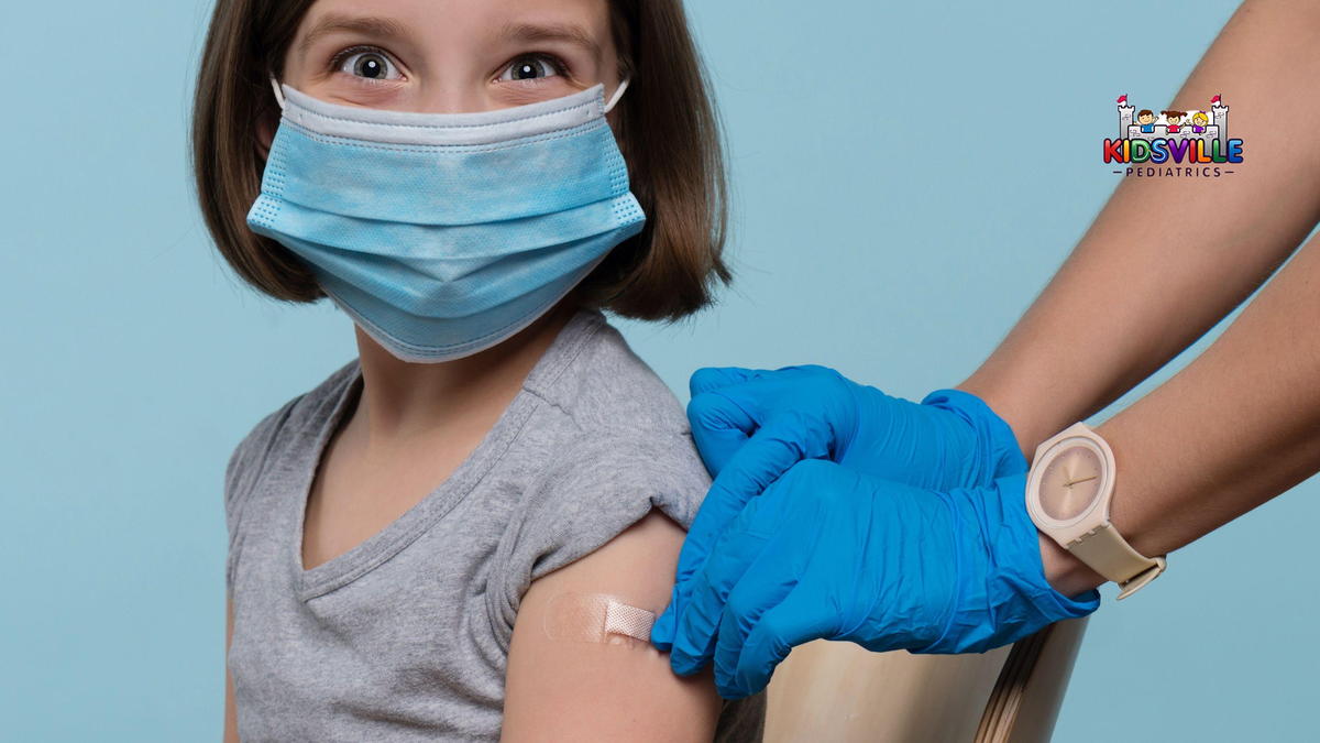 A young girl, smiling, after getting vaccinated.