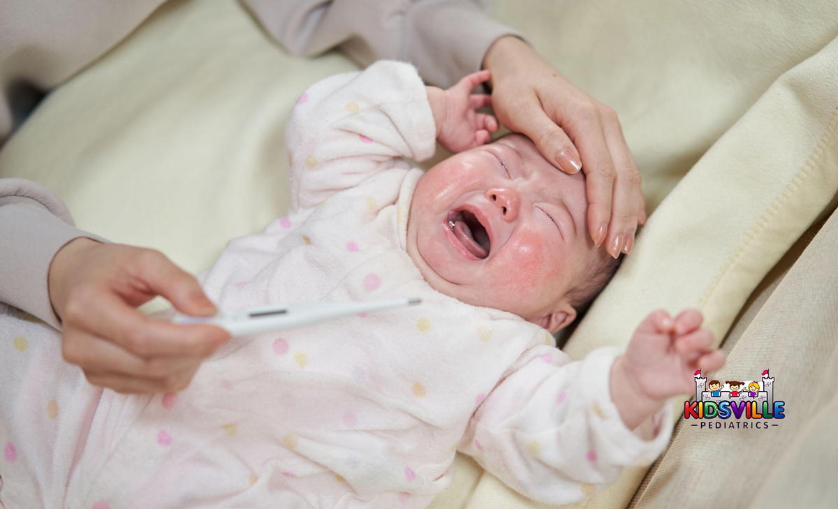 Asian baby crying with fever.