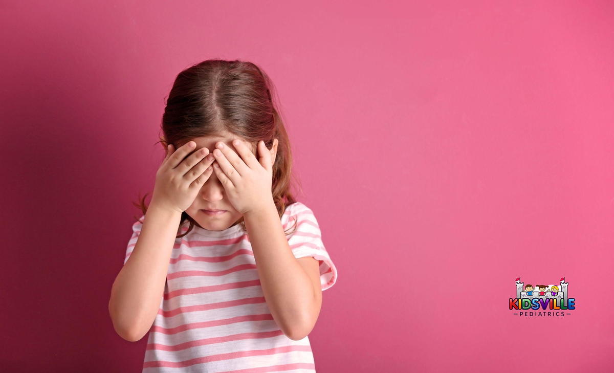 Little Girl Suffering from a Headache.