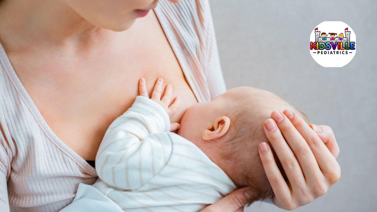 cropped shot of young woman breastfeeding baby on grey.