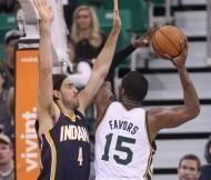 Utah Jazz's Derrick Favors (15) shoots as Indiana Pacers' Luis Scola (4) defends in the first half during an NBA basketball game Wednesday, Dec. 4, 2013, in Salt Lake City.  (AP Photo/Rick Bowmer)