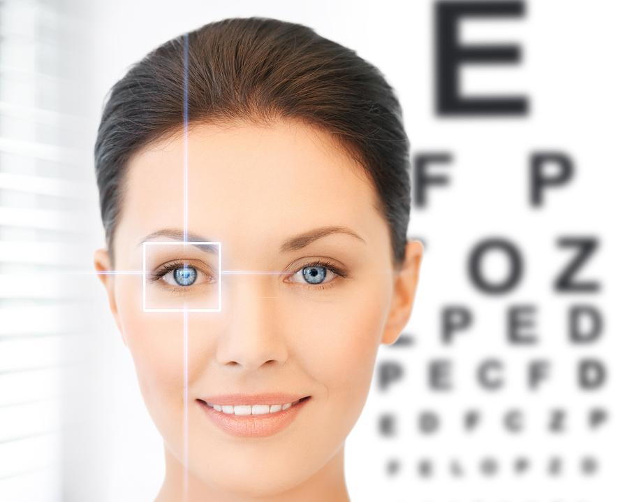 woman standing in front of an eye exam chart