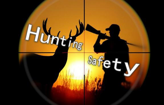 The view through a scope of a hunter and a buck deer silhouettes with the sunset behind.