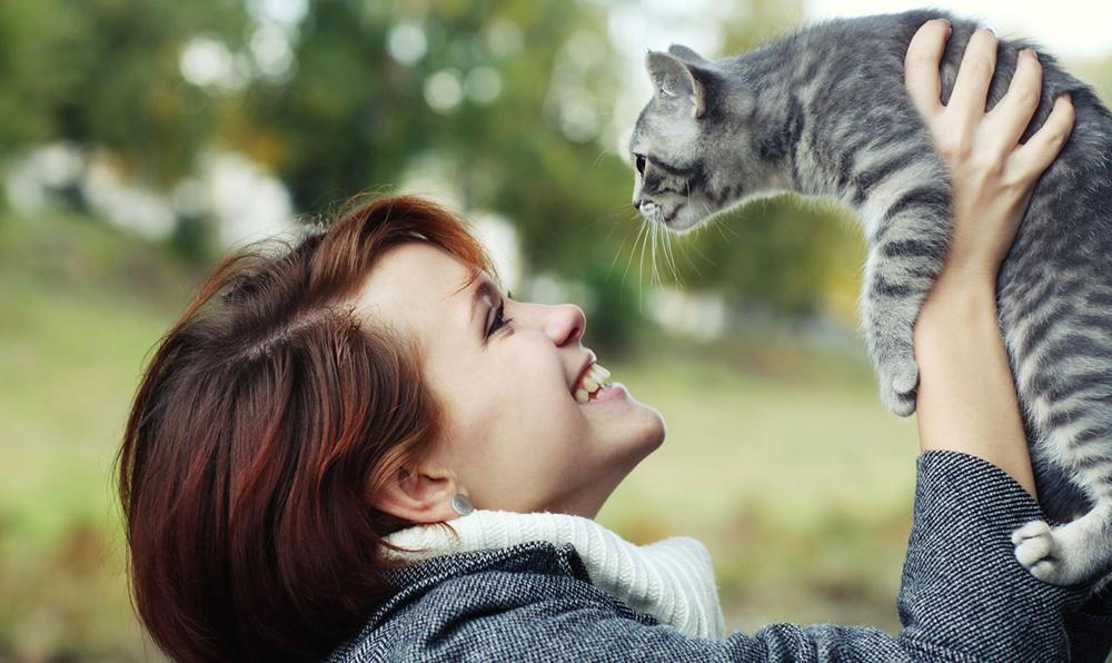 women holding her cat is allergic to her pet cat in laguna hills