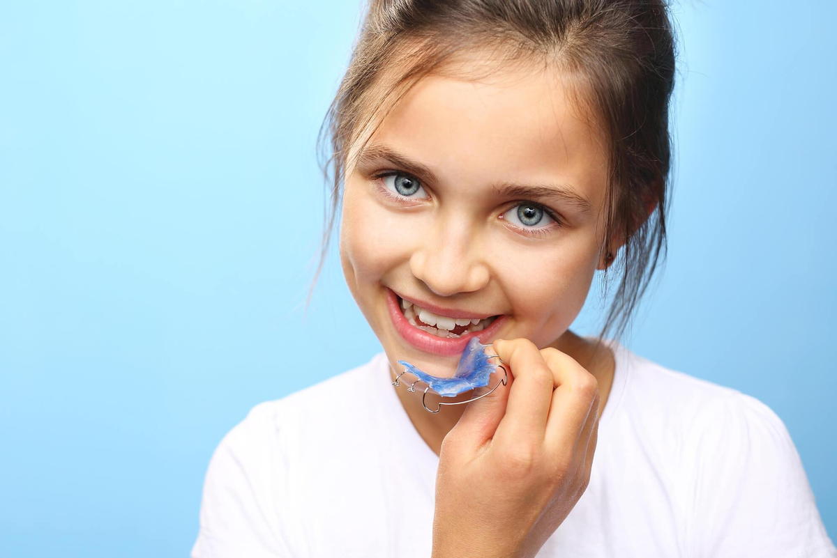 child with an orthodontic appliance from Commack pediatrics specialist