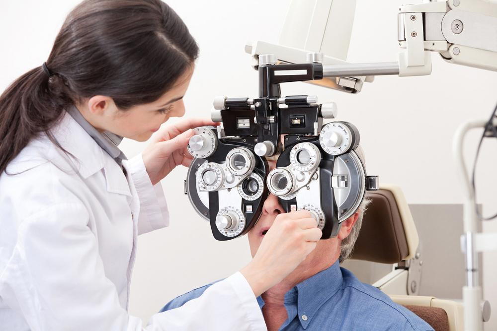 man getting a comprehensive eye exam from his optometrist in Jacksonville