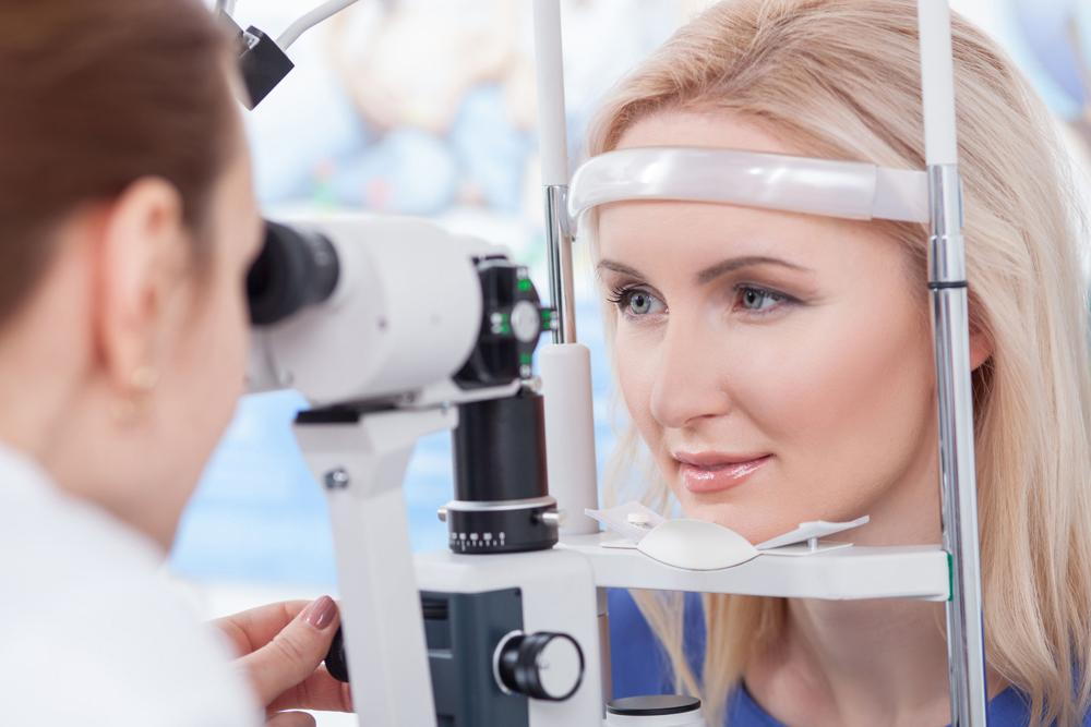 woman receiving an eye exam in order to have a healthy vision