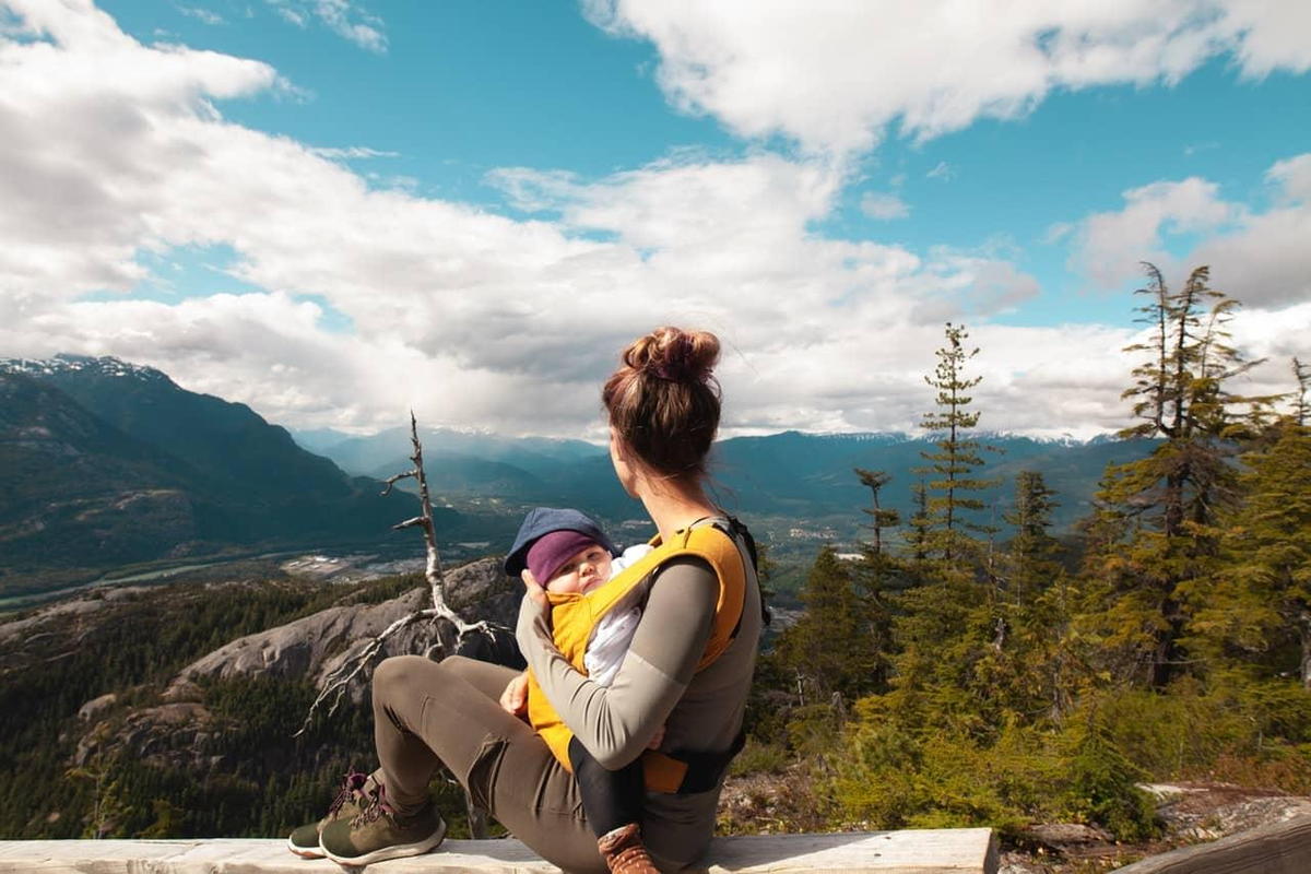 Mom with baby in mountains uses chiropractor to help
