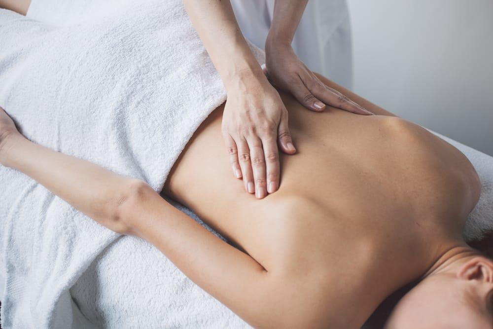 Woman receives a massage at knoxville spine and sports for a stiff neck.