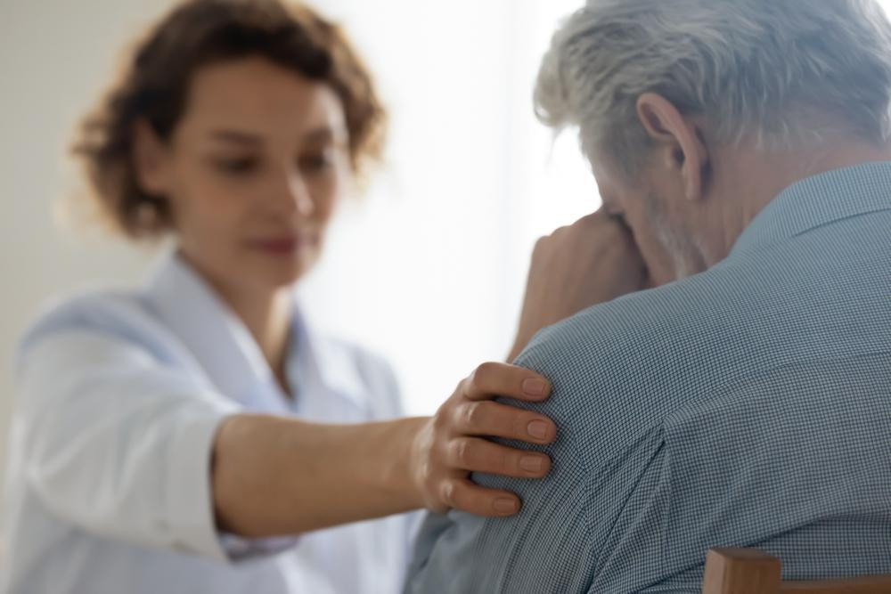 Patient crying with therapist comforting patient