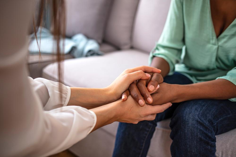 Therapist holding hands of patient