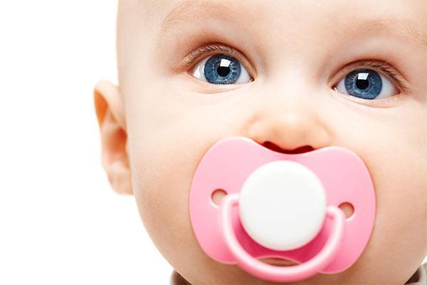 baby with pacifier teeth