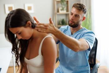 chiropractor treating female patient with head ache and migraine | chiropractic care for headaches and migraines