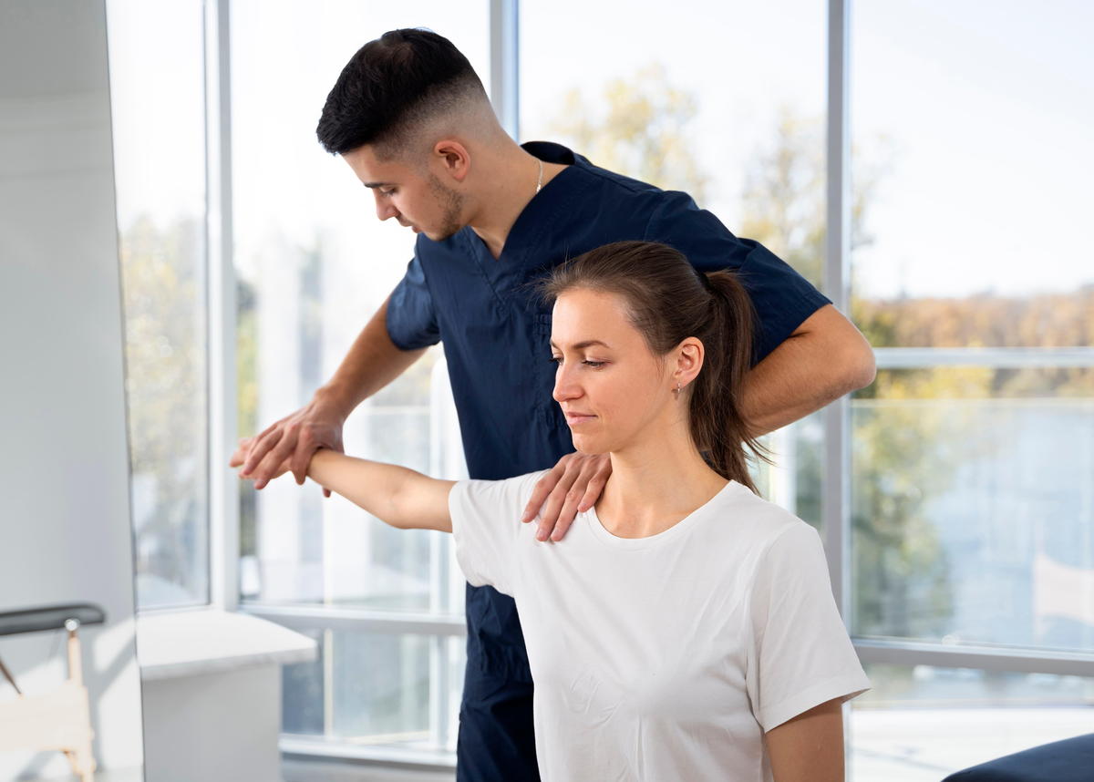 doctor providing Fibromyalgia female patient with chiropractic treatment