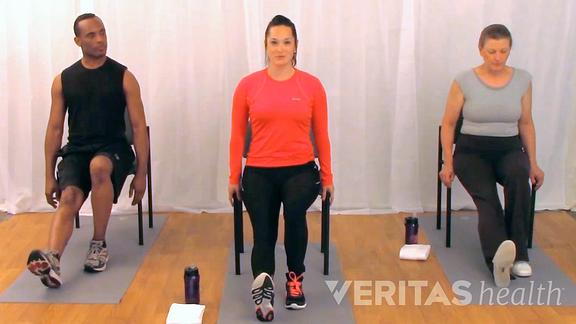 Image of three people doing the seated hamstring stretch for sciatica pain