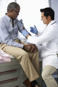 doctor giving a man a flu shot