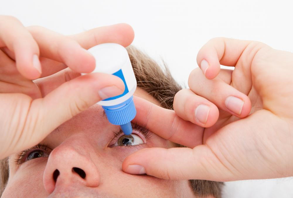 man with eye drops for dry eye from a Meridian Optometrist