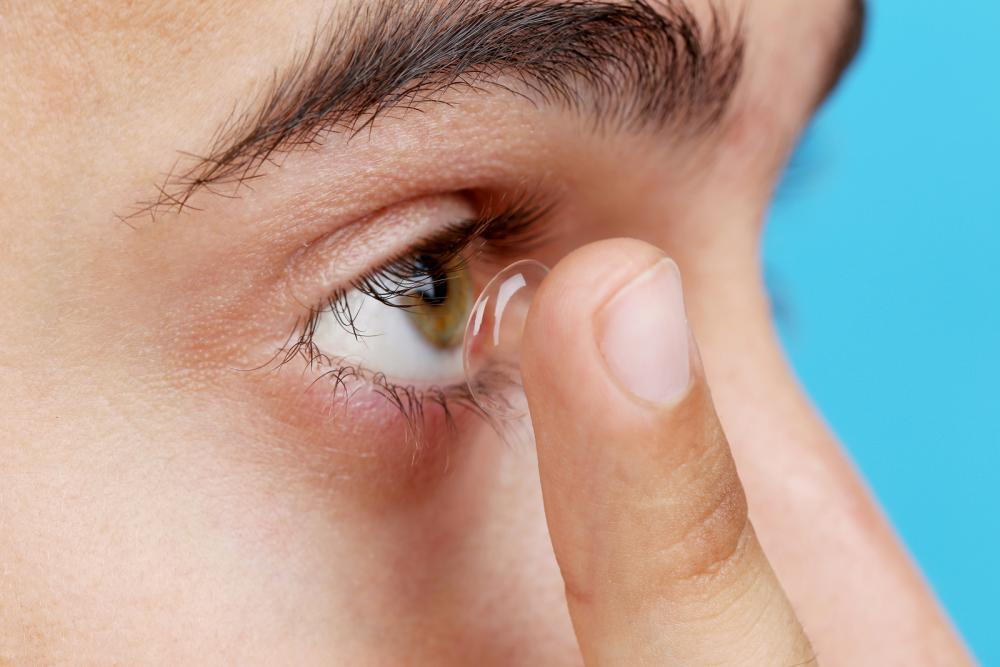 teen putting in contact lens from, lancaster, montpelier or st. Johnsbury optometrist