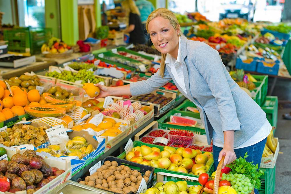 woman grabbing fruits and veggies at the market